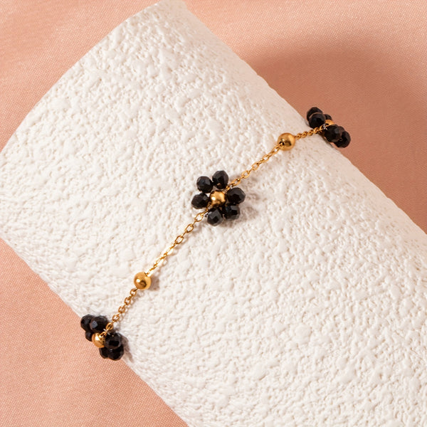 Pulsera dorada con flores