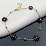 Pulsera dorada con flores