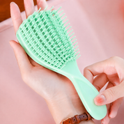 Mini cepillo desenredante flexible para cabello