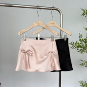 Mini falda de satín con moños