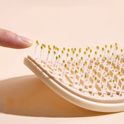 Cepillo desenredante con cubierta de limpieza fácil