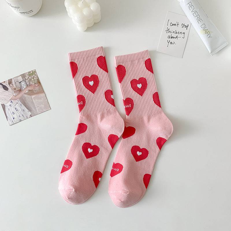 Calcetas altas rosadas con estampados girly