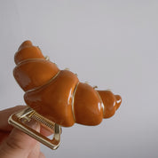 Gancho para cabello en forma de croissant