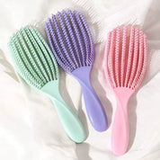 Mini cepillo desenredante flexible para cabello